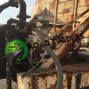Rusty industrial machinery with hoses and logo.