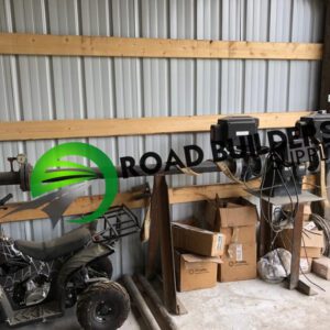 Workshop with equipment and boxes inside shed.