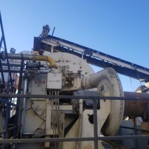 Industrial machinery against a clear blue sky.