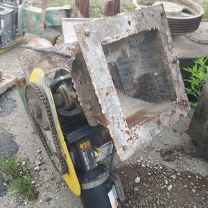 Small rusted gearbox with yellow pulley