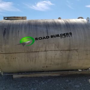 Large industrial tank on gravel ground.