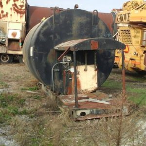 Rusty industrial equipment in a scrapyard setting.