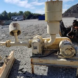 Old industrial machinery on gravel lot.