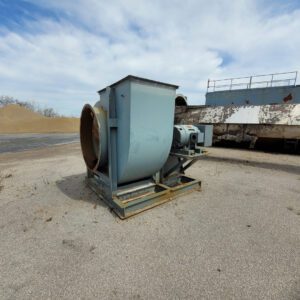 Industrial fan on concrete surface outdoors.