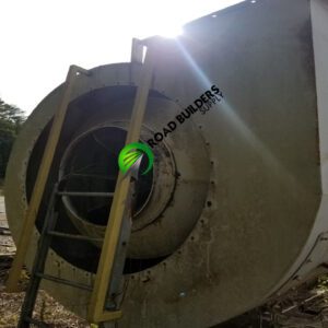 Industrial fan with ladder outdoors.