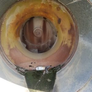 Rusty interior of industrial metal pipe.