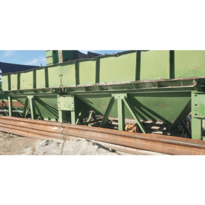 Large green industrial metal structure outdoors.