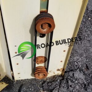 Rusty pulleys on industrial equipment panel.