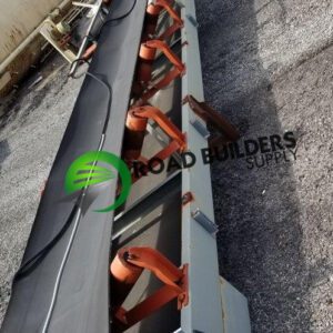 Conveyor belt on gravel surface, outdoor setting.