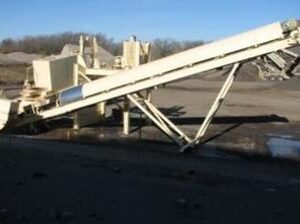 Conveyor system in an industrial outdoor setting.