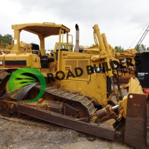 Yellow bulldozer parked at construction site.