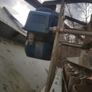 Blue industrial motor mounted on metal structure.