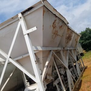 Large rusted industrial storage container outdoors.
