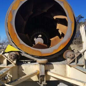 Rusty industrial pipe against clear blue sky.