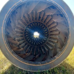 Inside view of large rusty turbine engine.