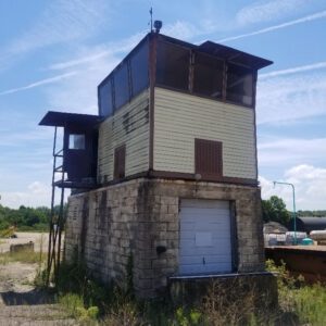 Old industrial building under clear blue sky.