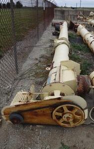 Old machinery beside a wire fence outdoors.