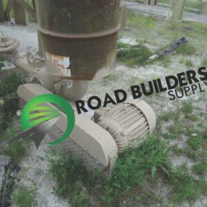 Beige electric motor beside rusted barrel outdoors