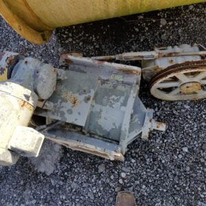 Detached motor and pulley assembly on gravel