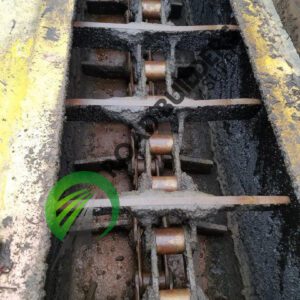 Rusty industrial chain gear with yellow frame.