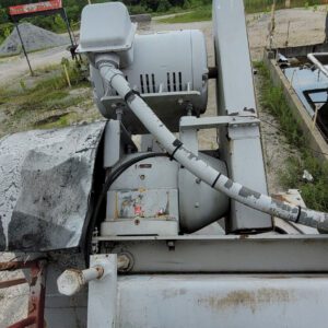 Industrial machinery with motor outdoors, overcast sky.
