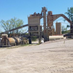 Industrial plant with machinery and storage tanks.