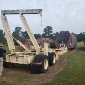 Trailer with tanks on grassy field.