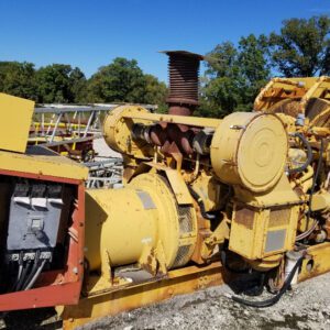 Yellow industrial generator on concrete platform.