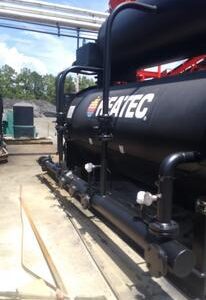 Industrial machinery with pipes and valves outdoors.