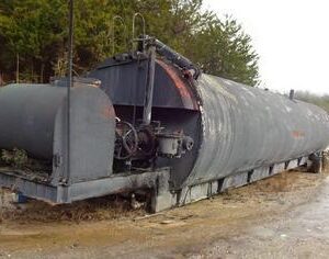 Rusty industrial tank on concrete blocks.
