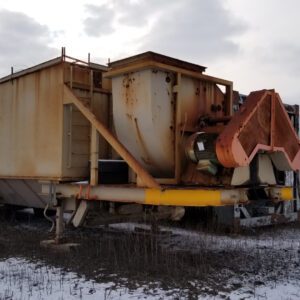 Rusty industrial equipment on snowy field.