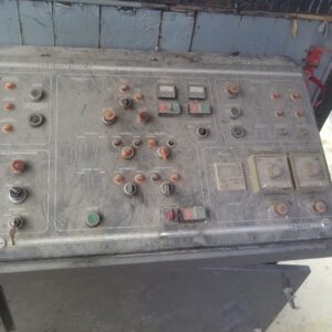 Old industrial control panel with buttons.