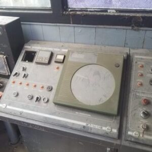 Old, dusty control panel with buttons and dials.