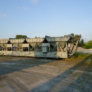 Industrial conveyor system on outdoor site.