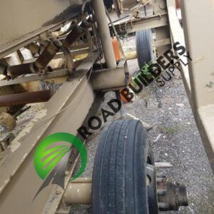 Damaged vehicle axle and tire close-up.