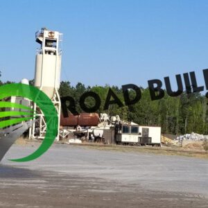 Construction site with machinery and gravel pile.