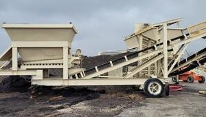 Mobile industrial conveyor system on construction site.