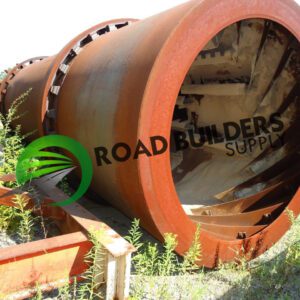 Rusty industrial cylinder lying on ground.
