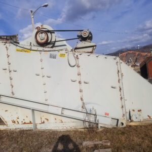 Large industrial machine on grassy field.