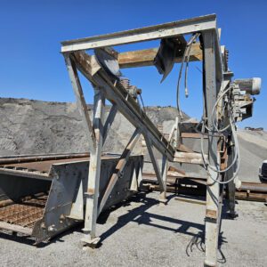 Industrial machinery in a gravel quarry setting.