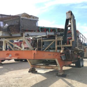 Industrial machinery on a flatbed trailer outdoors.
