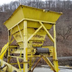 Yellow industrial hopper in a rural area.