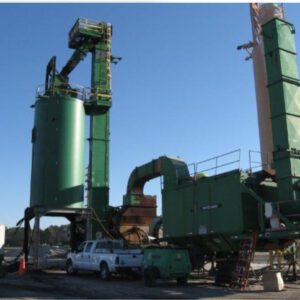 Industrial machinery with green towers and vehicles.