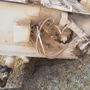 Dirty industrial machinery with exposed cables and components.