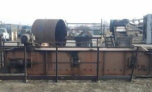 Rusty industrial machinery in outdoor storage area.
