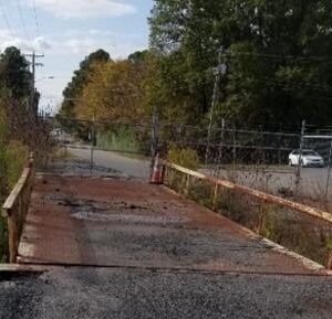 Old rusty bridge with traffic cone.