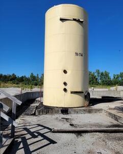 Large cylindrical tank in industrial area.