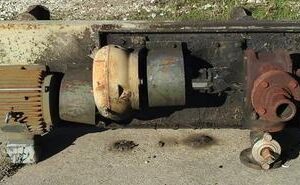 Old industrial machinery on concrete surface.