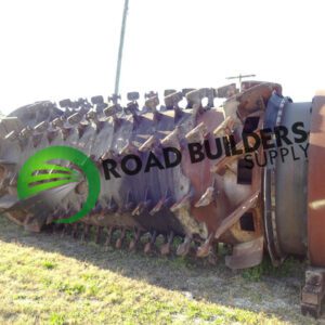Industrial machinery on grass with logo overlay.