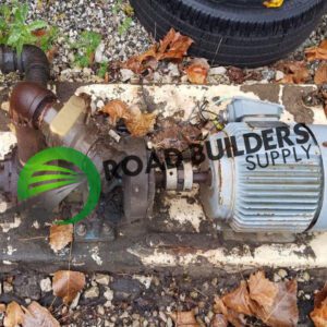 Old industrial pump with fallen autumn leaves.